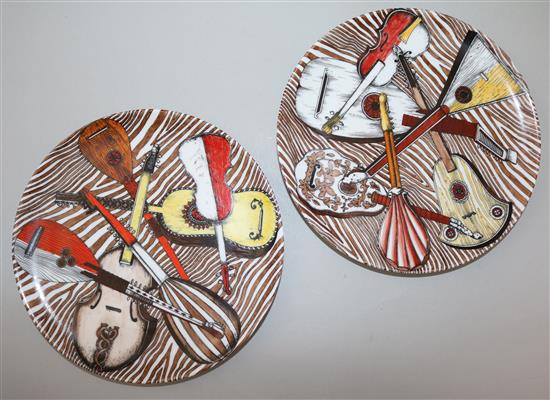 A large Fornasetti Strumenti Musicali pattern dish and four similar plates, 20.5.cm - 32cm